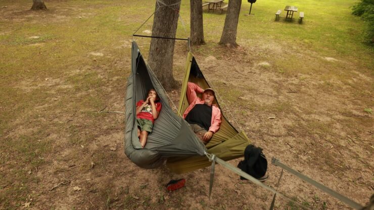 Sleeping side by side in two different hammocks